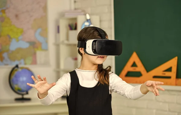 Modern technologies. virtual reality headset. teenage schoolgirl in classroom. back to school. In a Computer Science Class. Works on Programing Project. vr technology. schoolchild use virtual reality