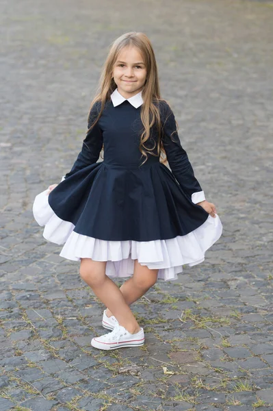 Elegant and classy. Happy child make curtsy in uniform outdoors. Dress code. Formal style. Fashion school uniform. Clothing standards. Elementary education. September 1 — Stock Photo, Image