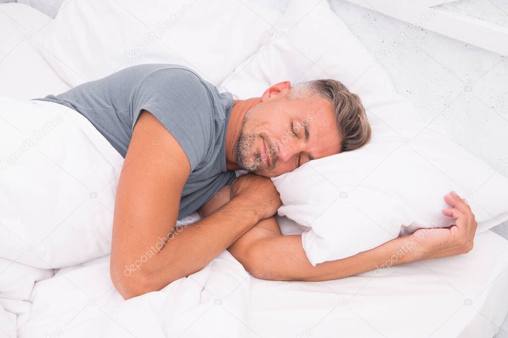 Sleeping guy at home. Relaxed man. Promote prevention and management of sleep disorders. World Sleep Day. Benefits of good and healthy sleep. Breathe Easily, Sleep Well. Handsome man in bed