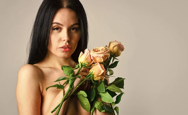 Spa treatments for skin rejuvenation. sexy naked woman hold rose flower. soft and tender. healthy woman hold rose with petals. sexy nude beautiful woman in flowers. love and romance. copy space — Stock Photo, Image