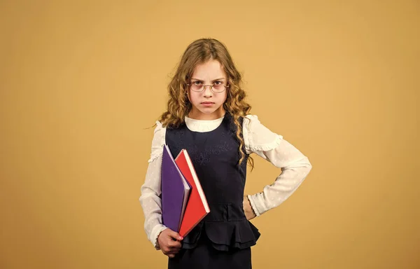 Prepare for exam. Formal education and homeschooling. Check knowledge. Final exam coming. Girl hold textbook folder test. School exam concept. Preparing to exams in library. Small child formal wear — Stock Photo, Image