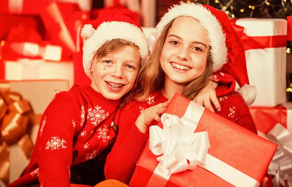 Cosy winter evening together. small kids friends have fun. santa helpers among red present boxes. too much gifts. online shopping. childhood happiness and carefree. family values for children — Stock Photo, Image