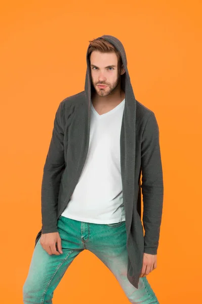 Casual menswear. Freedom of movement. Fashion trends. Modern clothes for youth. Sporty style. Fashion man yellow background. Fashion look. Handsome guy wear fashionable mantle with hood — Stock Photo, Image