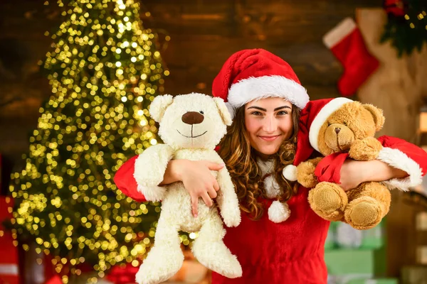 christmas party. christmas day is celebrated. new year tips and ideas. happy girl at xmas party. christmas shopping sales. happy santa woman bear toy present. at the toy shop. decorate your holiday