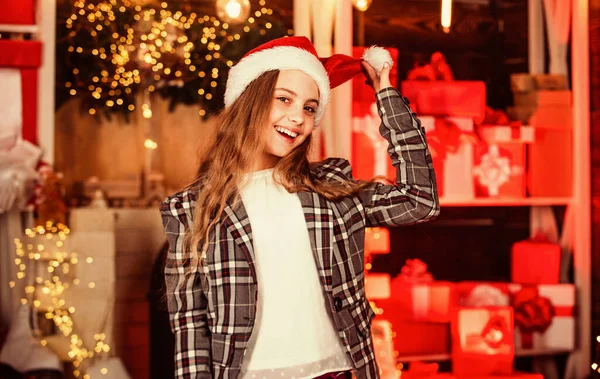 this is fun. presents and gifts for nearest. family holiday. small santa girl celebrate xmas. christmas composition. decorate your home and christmas tree. happy new year. happy child in santa hat