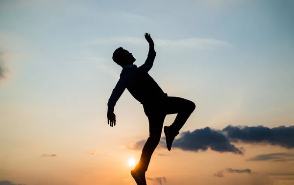 to be free. free man dancing. happiness. need the inspiration. man feel motivation. full of energy. dancer silhouette on sky background. confidence and success. concept of future