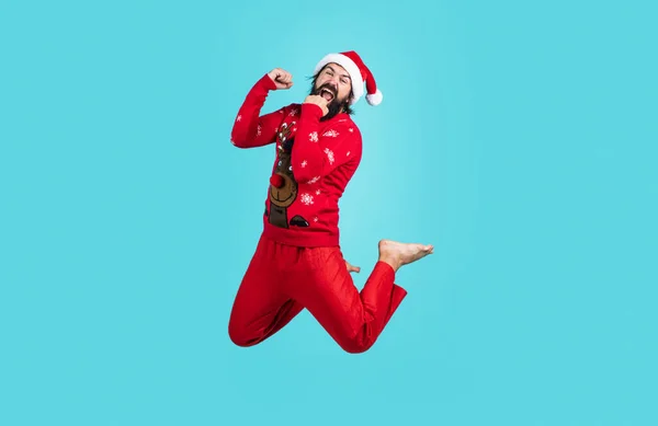 Incrível cara despreocupado pulando durante a sessão de fotos do ano novo no fundo azul, tempo de Natal — Fotografia de Stock