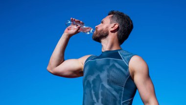 Sporcu adam antrenman, spor ve sağlıktan sonra susadığı için su içiyor.