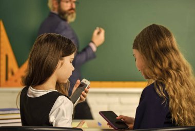 Araştırma yapıyordum. Yaratıcı çocuklarla çalışan öğretmen. Okuldaki küçük kızlar. Okula dönüyorum. Öğretmen ve öğrenciler ilkokulda masa başında birlikte çalışırlar. yaratıcılığı göster ve geliştir