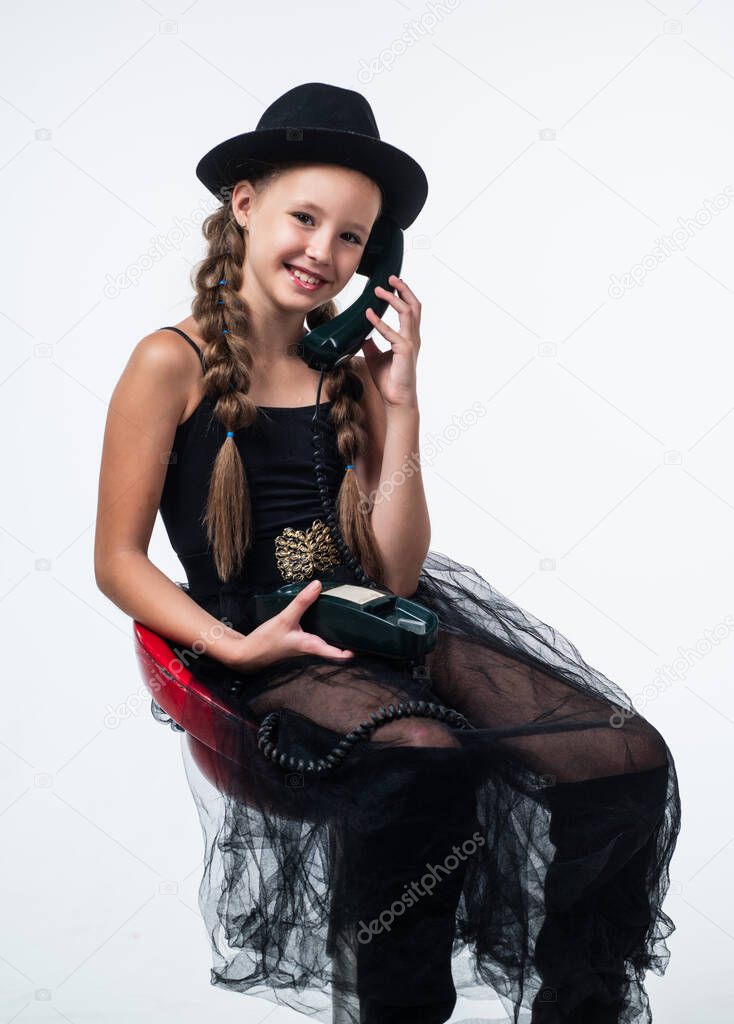 hello. communication in modern life. child with old fashioned vintage phone. old and new technology. teen girl in hat speak on phone. retro phone. happy childhood. kid has telephone conversation