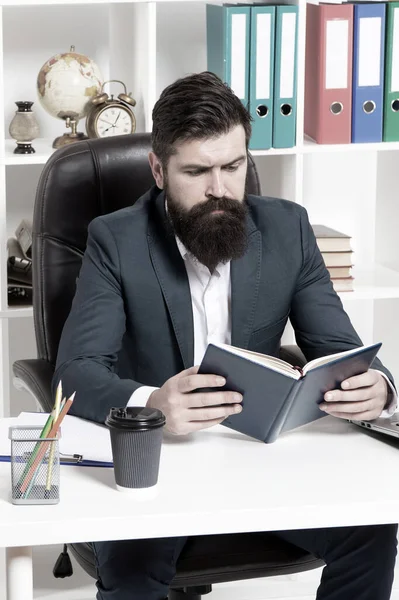 Reading authority business book. Man bearded hipster boss sit armchair office interior read book. Boss at workplace. Guy formal clothing corporate style working. Business literature. Boss read book
