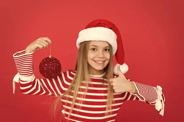 Christmas party. Winter holidays. Playful mood. Christmas celebration ideas. Shine and glitter. Child Santa Claus costume hat. Happy smiling face. Beautiful detail. Positivity concept. Cheerful mood — Stock Photo, Image