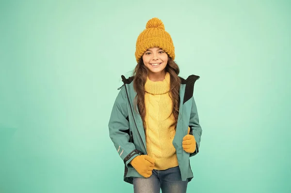 Winter vacation. Protective clothes. Winter collection. Child wear hat gloves jacket. Active leisure. Sporty style. Carefree childhood. Cute girl enjoy winter season. Little kid wear knitted hat