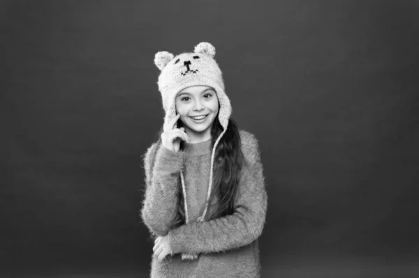 Atividade de férias ao ar livre. pequena criança pronta para o inverno. moda infantil. Dicas de tricô quente. cuidados de saúde sazonais. menina feliz em chapéu earflap. Menina feliz em chapéu de pele fundo vermelho — Fotografia de Stock