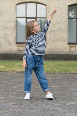 Şuna bir bak. Küçük çocuk şehir dışını işaret ediyor. Gösterişli bir jest. Pazarlama ve reklam. Satış ve dağıtım. Bilgi gösteriliyor. Giysi dükkanı. Çocuk kıyafetleri.