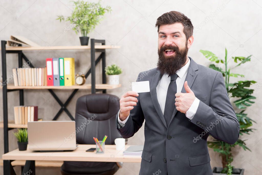 Card design. Guy formal suit stand in office. Businessman hold blank card. Useful contacts. Bearded hipster top manager show card. Banking services. Private lawyer. Call me if you have any questions