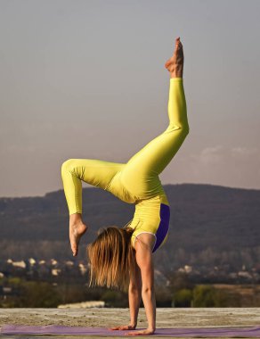 Sadece güçlenirsin. Açık havada esnek bir kız. Yoga yapan bir kadın. Kasları esnetiyorum. Spor hocası. Kadın jimnastik yetenekleri sergiliyor. Akrobatik jimnastik. Jimnastik sporcusu. Hiç kolaylaşmıyor.