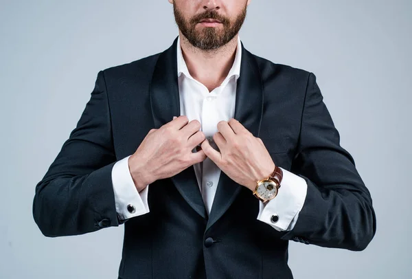 Bearded man get dressed formal style suit with open collar cropped view grey background, fashion