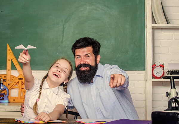 Developing caring learners who are actively growing and achieving. School learners leisure. Creating a community of learners. Teacher and schoolgirl. Man bearded pedagogue and pupil having fun