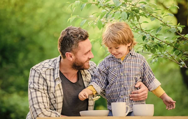 Happy family love. Child development. happy fathers day. Little boy with dad outdoor. childhood happiness. healthy food and dieting. Family day. son and father eating milk porridge — Stock Photo, Image