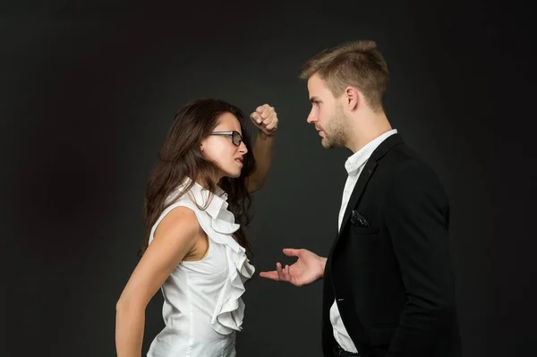 Colère professionnel femme serrer poing à mâle collègue dans formalwear sombre fond, lutte — Photo