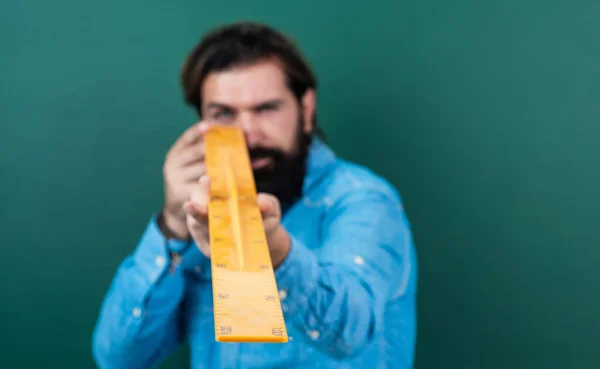 Homem sério com tamanho medido na ferramenta de matemática régua, conceito de tamanho, foco seletivo — Fotografia de Stock