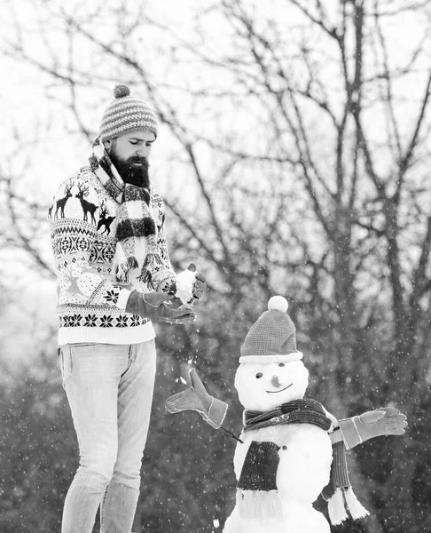 Winter flu. winter holiday outdoor. warm sweater in cold weather. man play with snow. winter season activity. its christmas. bearded man build snowman. happy hipster ready to celebrate xmas — Stock Photo, Image