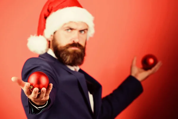 Spread magic christmas atmosphere. Radiate christmas generosity. Giving is better than receiving. Man with beard hold red balls christmas decorations selective focus. Winter holidays. Christmas mood