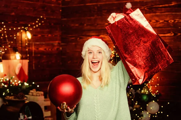 Slavnostní vánoční ozdoby. Zimní nákupy. Balíček s nákupem. Dívka držet míč na zdobení interiéru. Veselé Vánoce. Okouzlující dekorace. Vánoční ozdoby. Láska ke koupi dekorací — Stock fotografie