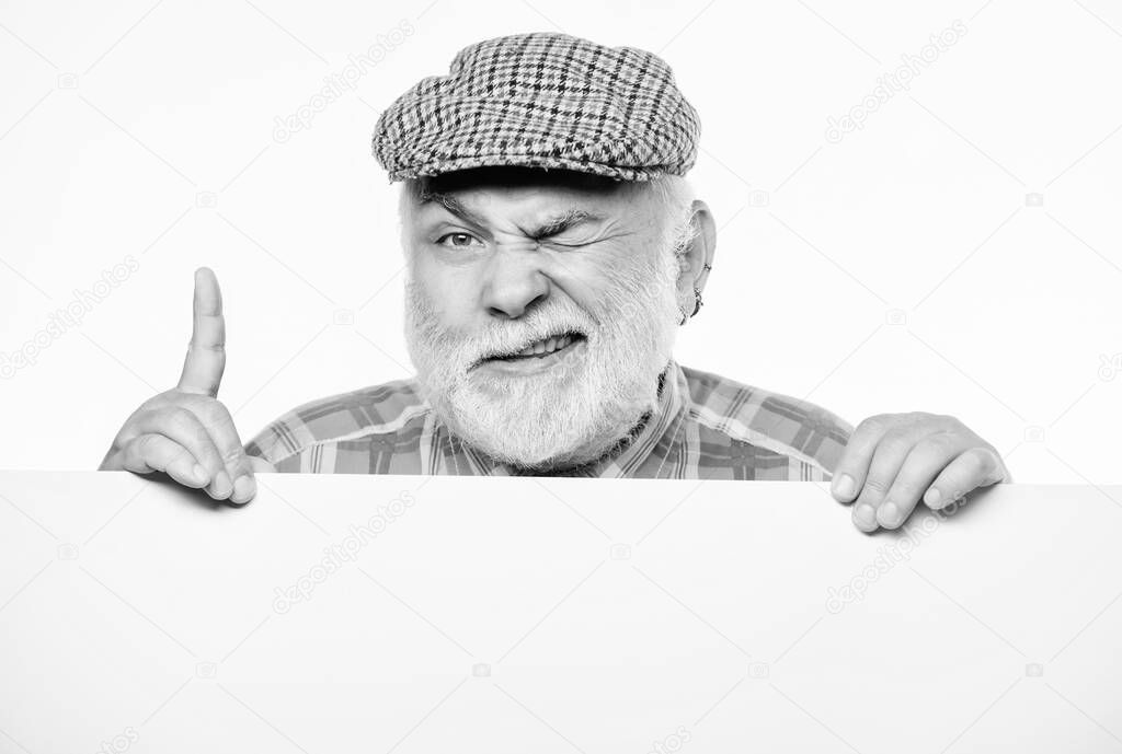 Elderly person. Senior bearded emotional man peek out of banner place announcement. Pensioner grandfather in vintage hat poster information copy space. Announcement concept. Event announcement