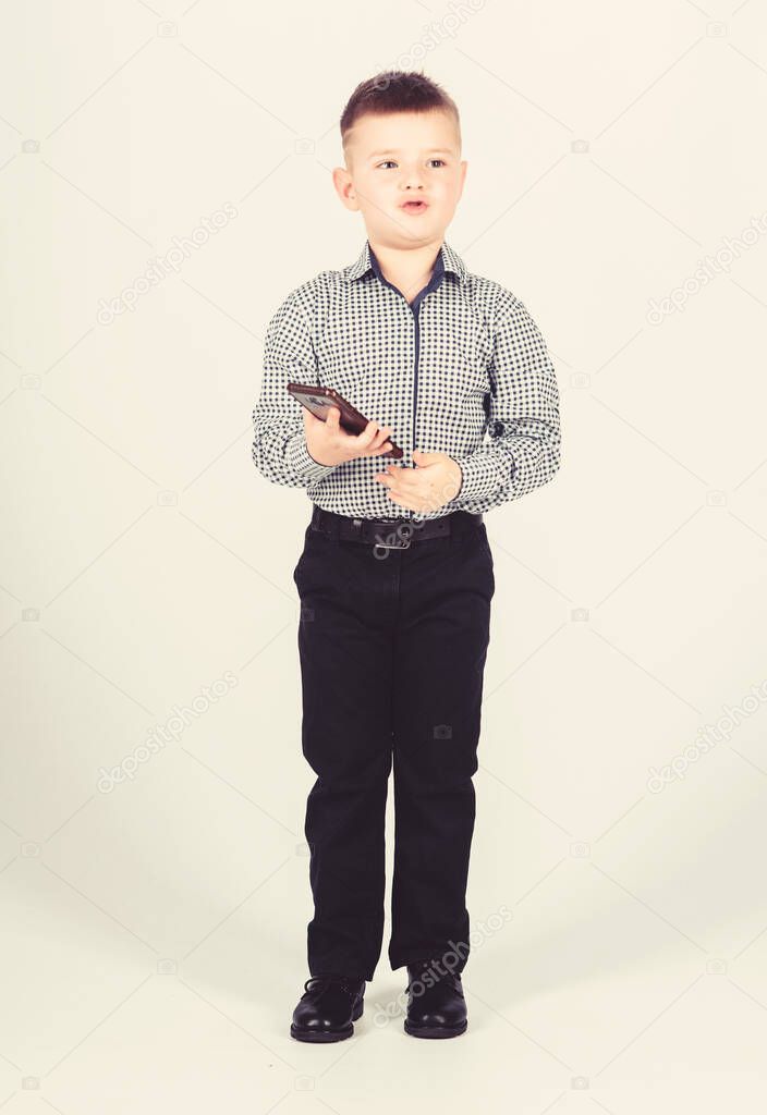 small boy with mobile phone. little boss. Ceo direstor. childhood. Business communication. confident child has business start up. Businessman. Office life. Conversation. Responding on business e-mail