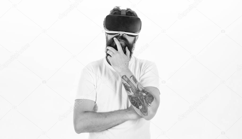 Man wearing virtual reality goggles in white background. Cheerful smiling man looking in VR glasses. Digital VR.