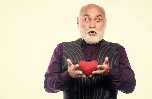 World heart day. Health care and treatment. problems with heart. bearded man has heart failure. love and romance. surprised mature man hold red heart. valentines day. donor transplant. copy space