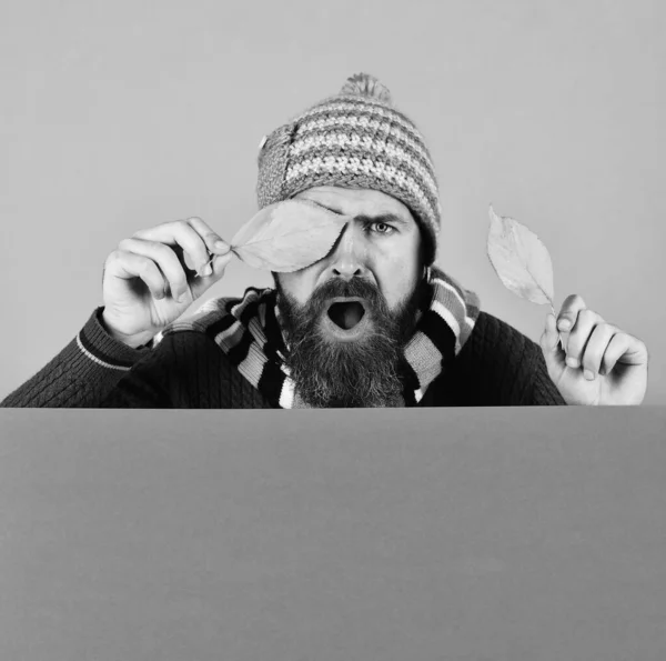 Hipster with beard and shocked face wears warm clothes. — Stock Photo, Image