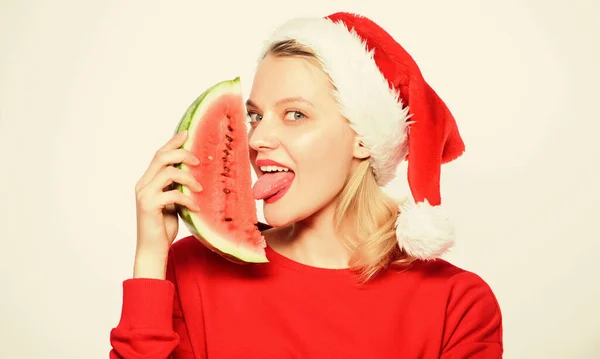 Christmas summer destinations. Christmas girl eat watermelon. Woman santa hat hold slice watermelon. Prolong summer. Travel christmas vacation and holidays resort. Delicious christmas concept