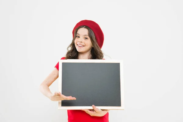 Big sales. child on yellow backdrop. back to school. Interesting info. happy girl in french beret. small girl kid with school backboard, copy space. information board. Fashion news. place for writing — Stock Photo, Image