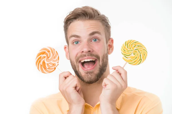 Impressing fact sugar nutrition. Man handsome bearded guy holds lollipop candy. Man with lollipop looks surprised. Healthy nutrition and dieting concept. Surprising effect sugar. Holiday sweet treats — Stock Photo, Image