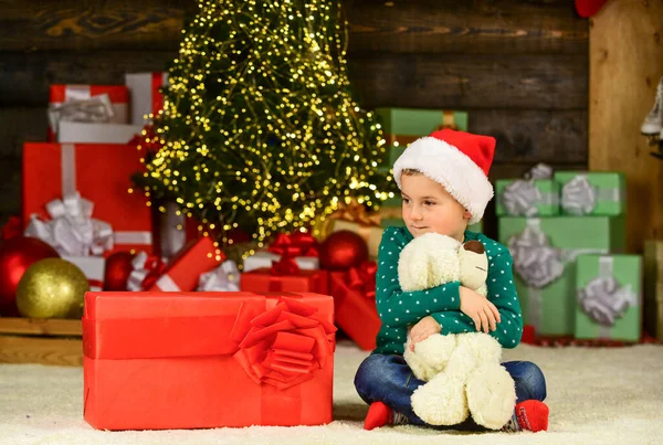 Find presents online. happy new year. happy child santa hat. son ready to celebrate winter holidays. small boy excited with present. kid hold bear toy gift. toy shop is open at xmas. merry christmas — Stock Photo, Image