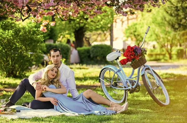 Perfect spring date. Long lasting relationship. Couple having picnic in local park. Couple sit blanket. Happy together. Romantic picnic. Idyllic moment in garden. Man and woman in love. Picnic time — Stock Photo, Image