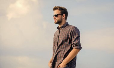 Ultraviyole koruma kavramı. Erkek gözlüklü model açık havada mavi gökyüzü arka planı. Yakışıklı adam güneş gözlüğü takıyor. Moda güneş gözlüklü hippi. Mükemmel görüş. Göz sağlığı. Moda güneş gözlüğü.