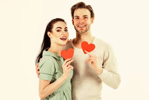 Valentines day and love. Romantic feelings concept. Man and woman couple in love hold red heart card on white background. Romantic couple in love hug. Handsome unshaven man and pretty girl in love — Stock Photo, Image