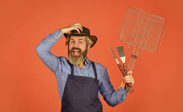 Picknick en barbecue. Biefstuk en barbecue. Barbecue. Eten grillen. Amerikaanse picknick. Familietraditie. Vlees aan het koken. Voorjaarsseizoen. Baard boer draagt hoed en schort voor barbecue. Roostervlees — Stockfoto