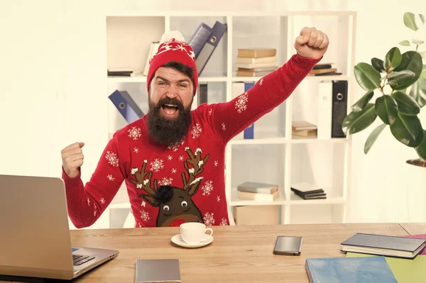 Hurray for the holidays. Happy hipster celebrate holidays in office. Bearded man smile with winter look. Happy holidays. Winter holidays or vacation. Holiday season. Christmas and new year