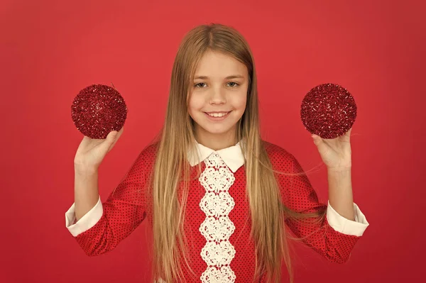 Red favorite olor. Create unique decorations. small girl child red wall. elf kid decorative tree ball. feeling happy about xmas. christmas shopping time. ready for new year celebration. Festive mood — Stock Photo, Image