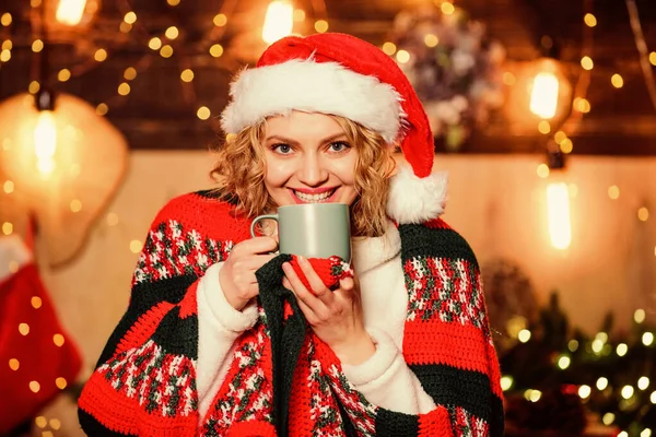 Tea shop concept. Warm and cozy. Cozy home. Enjoy cozy atmosphere of winter holidays. Woman drink tea christmas decorations background. Relax and recharge. Girl with mug of hot beverage relaxing