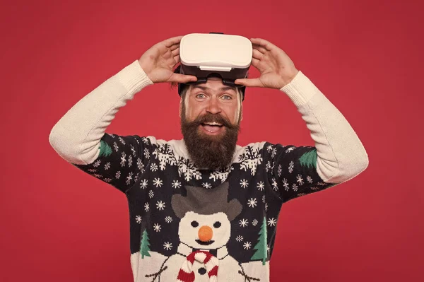 Man winter sweater play game. indoor vs outdoor activity. Virtual reality. man wearing virtual reality goggles. xmas party. happy bearded hipster in vr glasses. interacting with a virtual environmen — Stock Photo, Image