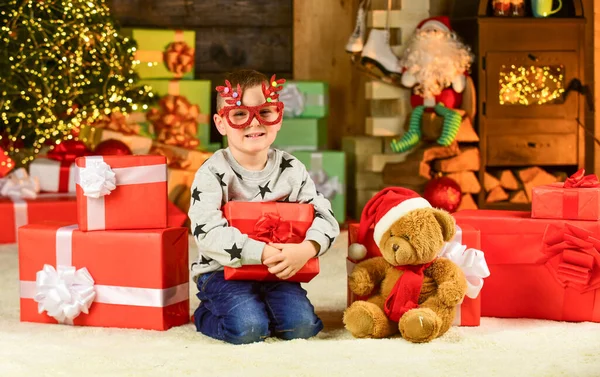 Christmas mood. kid hold decorative ball. bear toy gift for at xmas. merry christmas. happy new year. happy child party glasses. santa son celebrate winter holidays. small boy excited with present — Stock Photo, Image