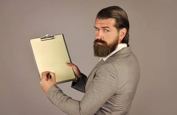 need your advice. portrait of bearded man making notes. Confident businessman holding folder for documents. business people and corporate concept. caucasian businessman with folder at office