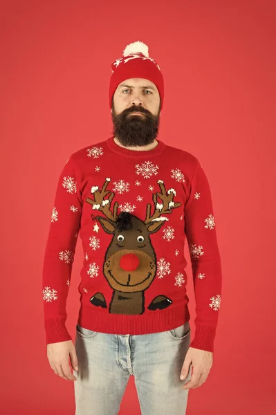 Still believe in santa claus. mature bearded man reindeer sweater. brutal hipster in knitted hat red background. wear christmas mood. knitwear male fashion. funny looking man. new year party — Stock Photo, Image