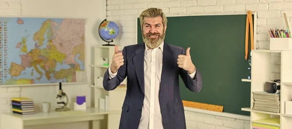 Teaching with interest. Verify achieved learning outcomes. Teacher school lesson. Study and education. Modern school. Knowledge day. Back to school. Emotional bearded man in classroom chalkboard